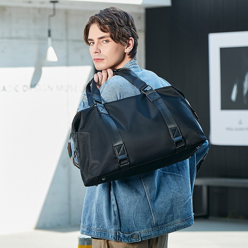 Spacious nylon men weekender duffle bag, equipped with carry handles and removable shoulder strap, perfect for short trip, gym and overnight travel.