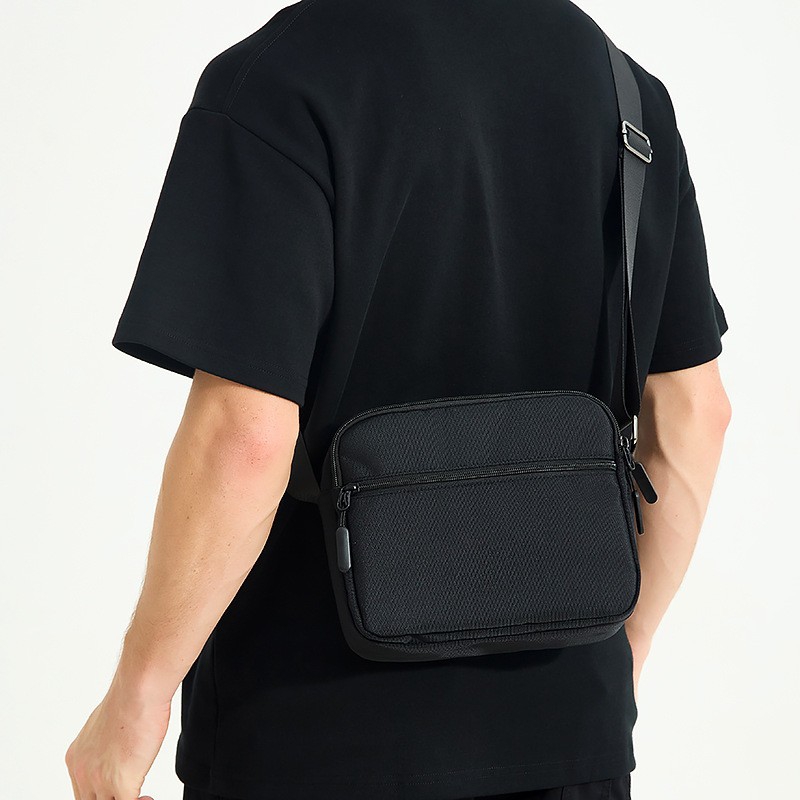 Compact men nylon crossbody bag with multi zipper compartments and adjustable strap, lightweight, suitable for daily outing and city commute.