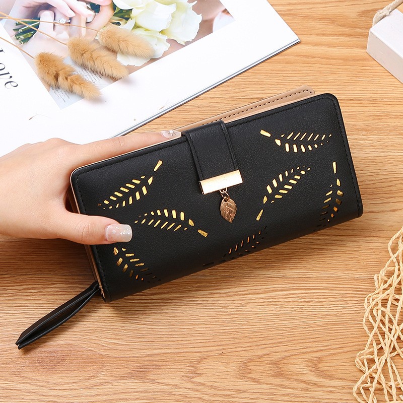 Women's long faux leather wallet featuring hollow leaf cutout pattern and snap closure. Available in various colors